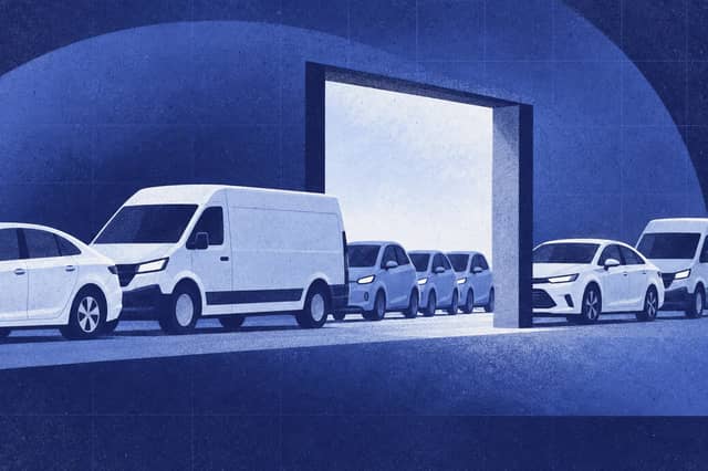 Editorial collage of Mixed exported vehicle convoy passing an aperture, with a smaller electric-car cluster lagging at the threshold.